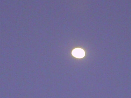 Moon in the blue sky. Close up of the moon. Coast of the Atlantic Ocean in Lanzarote Canary Islands Spainの写真素材