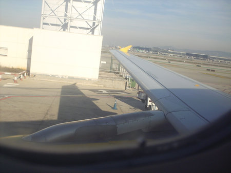 View of the wing of an aircraft from the window of an airplaneの写真素材