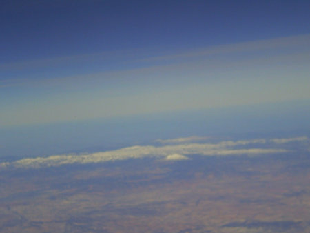 blue sky and white clouds as seen through window of an aircraft.の写真素材