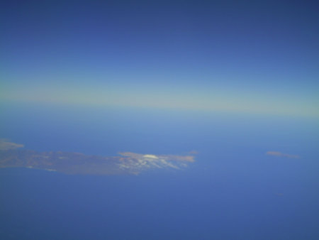 clouds in the blue sky as seen through window of an aircraftの写真素材