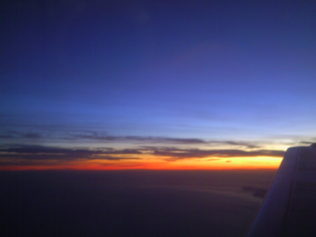 Sunset over the sea and the sky from the plane window.の写真素材