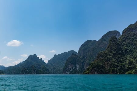 Lake view in blue sky with blur mountain backgground in summer season.