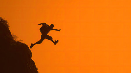 A silhouette of a determined adventurer leaping from a rocky cliff during a stunning sunset. The scene captures the essence of freedom and the thrill of exploration.の素材