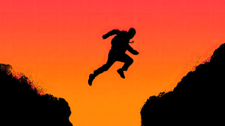 A dramatic silhouette of a man jumping across a canyon captures the essence of adventure against a vibrant sunset backdrop. Ideal for themes of exploration and courage.の素材