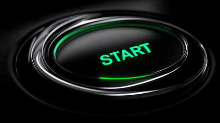 Close-up view of a glowing start button featuring bright green light. This image embodies innovation and serves as an ideal representation of modern technology concepts.の素材