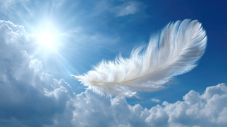 A delicate feather floats gracefully through a bright blue sky, surrounded by soft clouds and warm sunlight, symbolizing tranquility and freedom.の素材