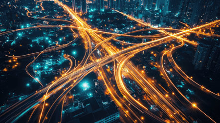 Captivating aerial view of a vibrant city at night, showcasing illuminated traffic patterns weaving through urban streets, highlighting modern infrastructure and dynamic movement.の素材