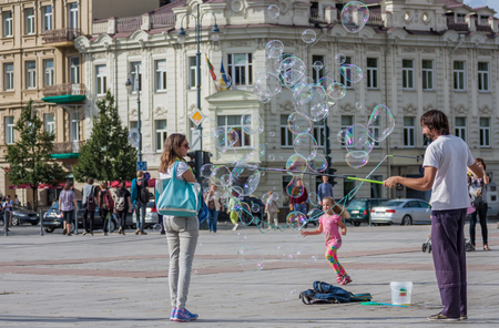 Vilnius is the capital and the main city of Lithuania, and the one in which every encounter is possible, even a street artist playing with huge soap bubblesのeditorial素材