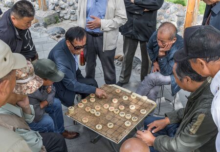 Urumqi, China - capital of the Xinjiang Uygur Autonomous Region, Urumqi is home of the colorful Uyghur ethnic group. Here in particular an everyday life scene in the People's Parkのeditorial素材