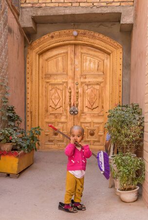 Kashgar, China - almost 85% of Kashgar inhabitants are Uyghurs, a minority Turkic ethnic group culturally affiliated with Central Asia populations. Here in particular an example of Kashgar Uyghurs