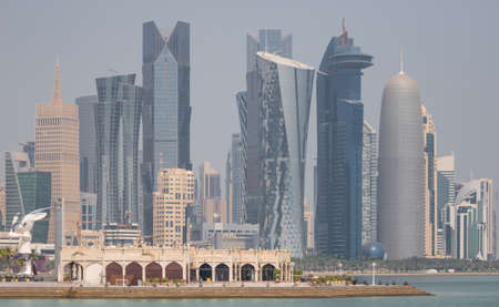 Doha, Qatar - probably the most notable landmark in Doha, the Corniche is a waterfront promenade extending for seven kilometers along Doha Bay. Here in particular its skylineのeditorial素材