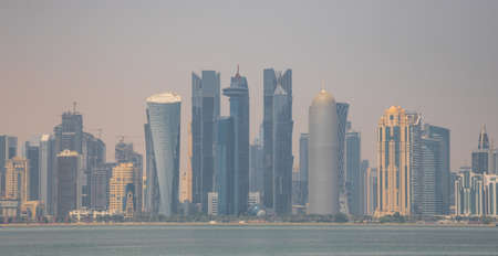Doha, Qatar - probably the most notable landmark in Doha, the Corniche is a waterfront promenade extending for seven kilometers along Doha Bay. Here in particular its skylineのeditorial素材