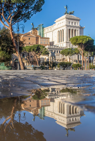 Rome, Italy - in Winter time, frequent rain showers create pools in which the wonderful Old Town of Rome reflect like in a mirror. Here in particular Via dei Fori Imperialiのeditorial素材