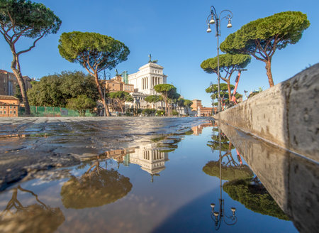 Rome, Italy - in Winter time, frequent rain showers create pools in which the wonderful Old Town of Rome reflect like in a mirror. Here in particular Via dei Fori Imperialiのeditorial素材