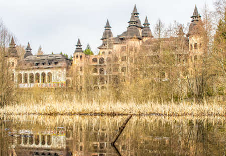 Åapalice, Poland - built in 1983 but never finished, the ruins of Åapalice Castle are an interesting tourist attractions in northern Poland. Here in particular its shape reflecting in the nearby lakeの写真素材