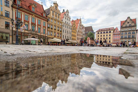 Wroclaw, Poland - due to the frequent rain, in Wroclaw you can easely find water pools, and use them to make nice shots. Here in particular the mirror effect in the Old Townのeditorial素材