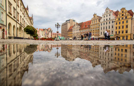Wroclaw, Poland - due to the frequent rain, in Wroclaw you can easely find water pools, and use them to make nice shots. Here in particular the mirror effect in the Old Townのeditorial素材