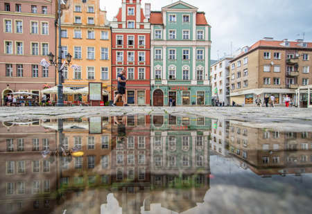 Wroclaw, Poland - due to the frequent rain, in Wroclaw you can easely find water pools, and use them to make nice shots. Here in particular the mirror effect in the Old Townのeditorial素材