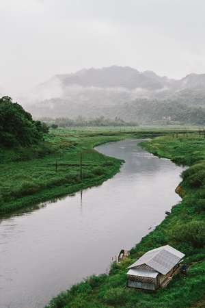 house river side in fog and haze after rain kanchanaburi thailandのeditorial素材