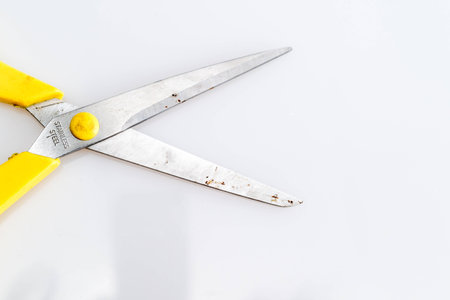 yellow used scissor on white background isolatedの写真素材