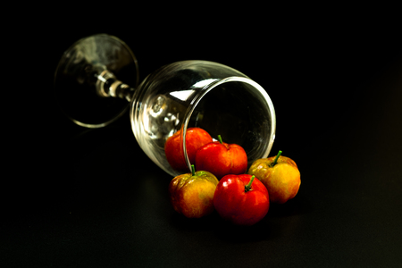Barbados cherry,Ripe thai cherry with glass on black background.の写真素材