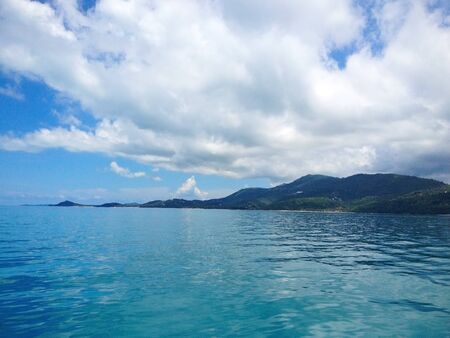 Beautiful white clouds on blue sky over calm sea