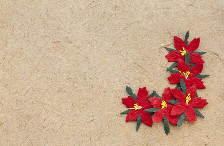 Brown natural handmade paper with red christmas flowersの写真素材