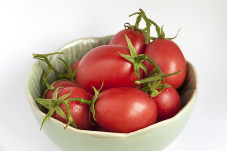 Close-up fresh tomatoes in green bowlの写真素材