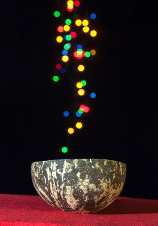 Coconut shell cup with colourful bokehの写真素材