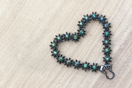 Beautiful flowers earring heart shape with green leavesの写真素材