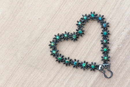 Beautiful flowers earring heart shape with green leavesの写真素材