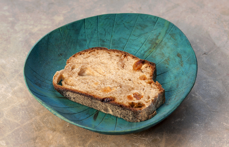 A piece of raisin bread in the green coconut shellの写真素材