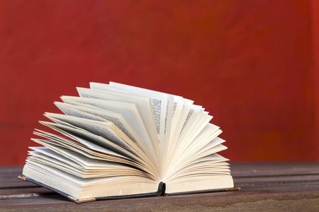 Book open with red backgroundの写真素材