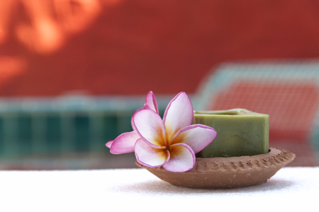 Candle in red clay tray with red backgroundの写真素材