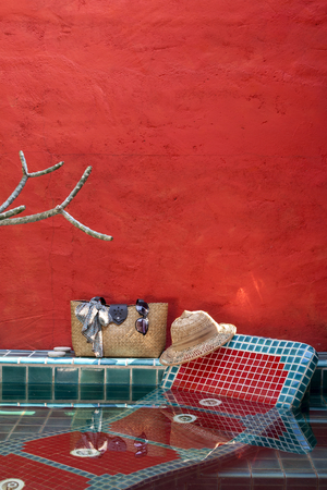 Holiday concept at the pool side with space on red cement wallの写真素材