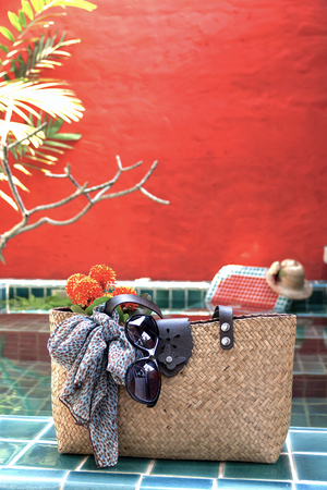 Holiday concept bag and red wall backgroundの写真素材