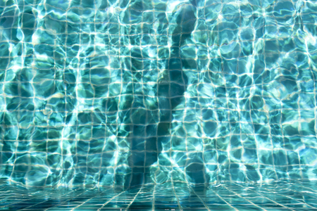 Crystal clear swimming pool water texture backgroundの写真素材