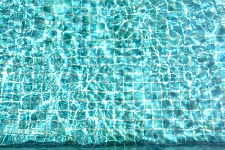 Swimming pool water sun reflection on water backgroundの写真素材
