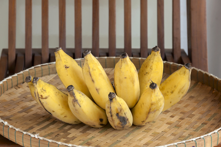 Yellow banana on bamboo trayの写真素材