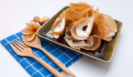 Closeup Thai crispy pancake on blue napkin with space on white の写真素材