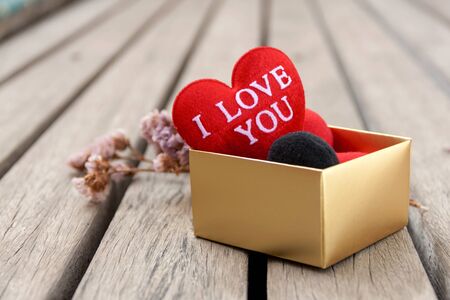 Closeup red  heart in gift box with wood floor backgroundの写真素材