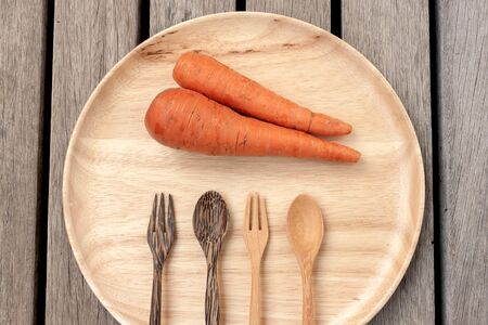 Carrot on wooden plateの写真素材
