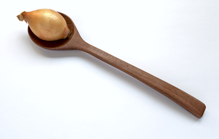 Onion on wooden spoonの写真素材