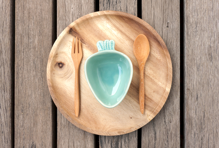 Wooden plate and green ceramic bowlの写真素材