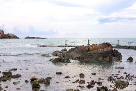 Rock in the sea in the morning lightの写真素材