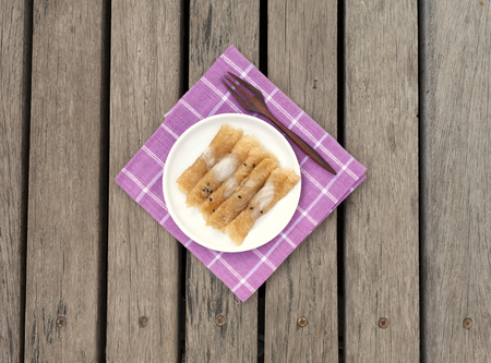 Thai snack on purple napkin and wood background center