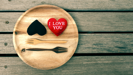 Vintag tone style black and red heart with space on wood floorの写真素材