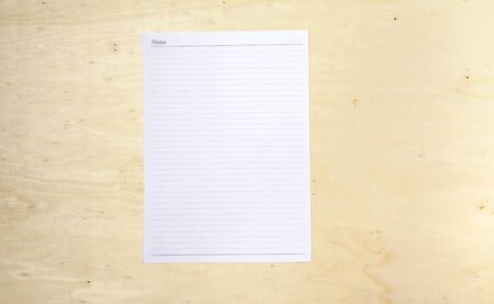Blank white note sheet on wood backgroundの写真素材