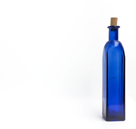 Blue glass bottle with space on white backgroundの写真素材