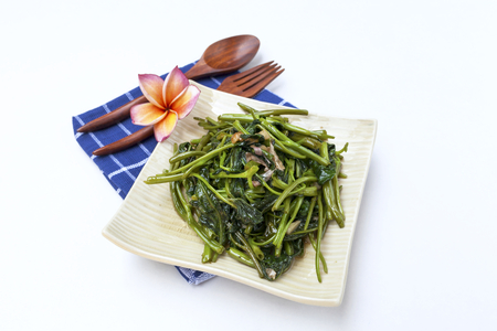 Closeup Stir fried morning glory with soya sauce on white background horizontal styleの写真素材